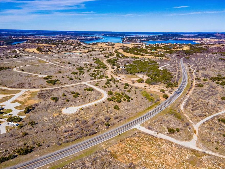 LARGE LOT in The Cliffs Resort. On the end of the cul-de-sac. Fairly level, and ready to build. Enjoy all the amenities the community has to offer, including 36 complementary rounds of golf on Texas's Championship golf course, marina, boat dock, restaurant, club house, fitness center, tennis courts, 2 pools, and much much more. Come enjoy the sparkling waters of Possum Kingdom Lake and build your own retreat in this amenity rich community. This is a gated and guarded community. Contact a local agent to set up a time to visit.