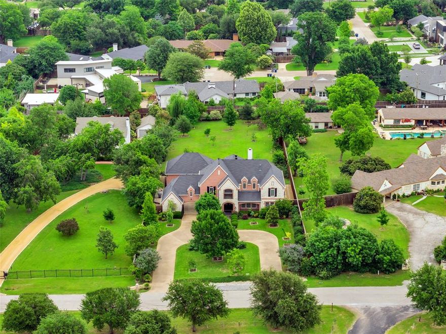 Set on a .75-acre lot, this impeccably maintained 4,695 square foot residence in Dallas’ coveted private school corridor area offers something the surrounding market cannot: land. While comparable homes in this price range are newly constructed on minimal footprints, this property delivers three-quarters of an acre that is private, quiet, and lush. Ideally situated just minutes from neighborhood favorite restaurants and shops, and with quick and easy access to freeways and both Dallas airports, this property offers an unbeatable location. The thoughtfully designed floor plan enables sweeping views of the large backyard and is perfect for entertaining. Custom millwork, cabinetry, and built-ins reflect a level of craftsmanship rarely found at this scale. With a lounge or piano room and an elegant dining room off the entry, the heart of the home is the open-concept kitchen and breakfast area, connected to the spacious family room with a fireplace and custom built-ins. On the main level, the large, comfortable primary suite offers seclusion, as does the sizable home office. Upstairs, you’ll find three generously sized bedrooms and two full bathrooms. A large game room provides a separate gathering space. An additional flex room could be a fifth bedroom, craft room, or office. The property includes a two-car garage plus a separate one-car garage, both accessed via a gated driveway for added privacy and security. The home boasts exceptional storage throughout. Step outside to a stunning 31' × 26' deck made for Texas evenings. The grounds are landscaped with native trees and plants, including fig trees, blackberry bushes, and gardens that produce generously each season. The remainder of the expansive backyard is a blank canvas for whatever you envision, such as a backyard oasis or multi-generational living. This property offers a rare opportunity to own a spacious home on 0.75 acres in one of Dallas’ most desirable and centrally located neighborhoods.