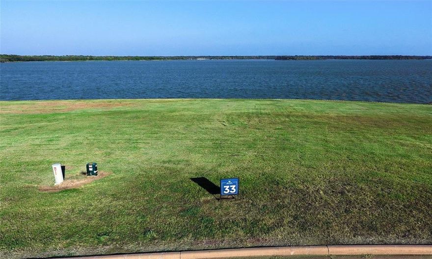 SWEEPING VIEWS greet you on this nearly half acre lot in the exclusive, gated subdivision of Beacon Hill on Cedar Creek Lake. You are 45 minutes from Downtown DALLAS. The planners have thought of everything. Infinity pool, clubhouse, nature trails, sandy beach, fishing, pickle ball court, Gorgeous marina with your own boat slip - all in place for enjoying right now. Extremely friendly architectural guidelines and build time. Buy your lot now, build later. Amenities you will appreciate: Retaining Wall maintained by the developer, concierge services, several recreational ponds and streams within the property, barbecue grills, high speed internet. This is large, open water - there are very few open water lots available on Cedar Creek Lake, many of the waterfront lots in Beacon Hill are sold. This lot has 180 degree views. Call the listing agent to see or if you're a real estate agent, please contact Broker Bay.