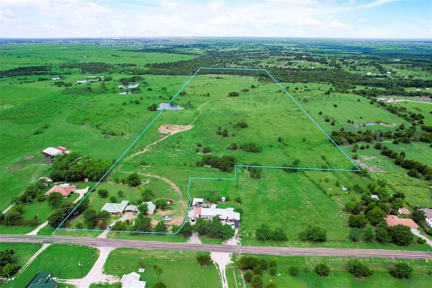 Here is a perfect opportunity to own a charming home on 63 acres located just 4 miles from IH45 in Ennis, TX! This is a one owner, three bed, two bath home that has been loved and well maintained since it was built. The home has been meticulously cared for and it shows throughout the house. The split bedrooms provide privacy while the living, dining, and kitchen areas provide plenty of space for the family to enjoy together. The property features a two car covered carport and a 19' x 39' metal shop that provides work space and storage. The 63 acres of native pasture includes rolling hills, scattered trees, a nice pond, and cross fencing. Bluebonnets and other wild flowers flourish here in the spring months! The pasture is ideal for cattle and other livestock as well as recreational opportunities for the whole family. Enjoy hunting, fishing, horseback riding, ATV trails and much more on this expansive property! This property offers a unique blend of rural charm and practical amenities.