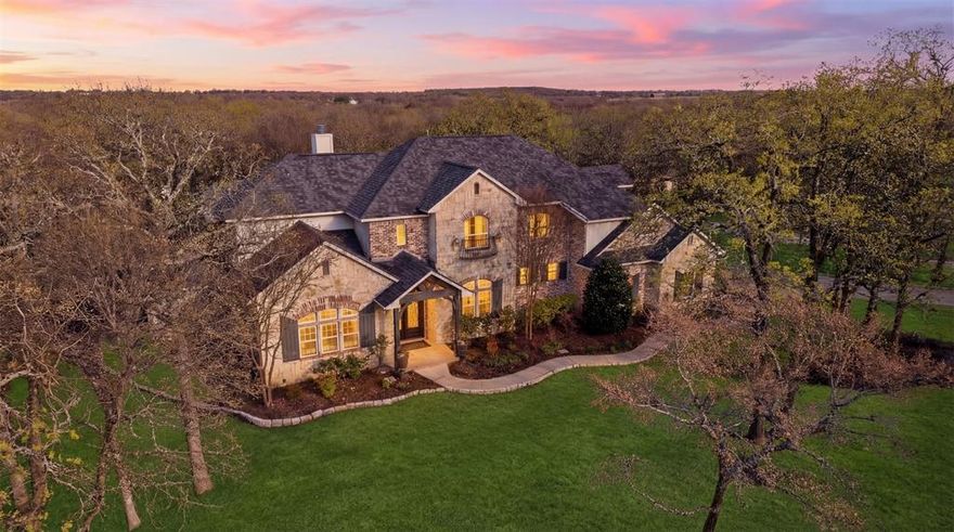 Welcome to peaceful country living in the heart of Pilot Point’s renowned horse country. Situated on nearly 1.5 heavily treed acres, this beautifully designed home offers the perfect blend of luxury, privacy, and character just outside the city.


A custom-trimmed entry with soaring ceilings opens into an expansive living area featuring rustic beams, a stunning stone fireplace, and a full wall of windows overlooking the serene backyard. The kitchen is designed for gathering, centered around an oversized island and a gas range with a striking brick surround, plus a dining area with a built-in banquet for casual meals and entertaining.


Thoughtful details throughout the home add warmth and personality, including custom board and batten accents, a dedicated home office with stamped concrete floors, and a first-floor media room. The spacious primary suite serves as a true retreat, complete with split his and her bathrooms, a dual-entry shower, and a built-in storm shelter discreetly located within the suite.


If you’ve been searching for space, privacy, and a home that truly feels like an escape, this exceptional property in Pilot Point delivers the best of country living with refined style.