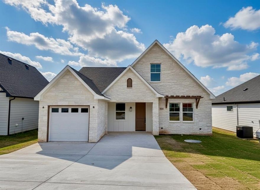 Discover the pinnacle of sophisticated living in this brand-new construction by renowned Builder Carrera Homes, where modern farmhouse charm seamlessly blends with timeless European flair. Nestled in the coveted lakefront community of Canyon Creek, this stunning residence boasts a captivating stone exterior that exudes curb appeal and durability, setting the tone for the exceptional craftsmanship within.

Step inside to an expansive open floor plan bathed in natural light, designed for effortless entertaining and everyday comfort. The heart of the home is a gourmet kitchen featuring custom cabinets throughout in bright, airy tones that create a fresh and inviting atmosphere. The kitchen island steals the show with a playful sage green pop of color, perfectly complementing the high-end finishes and providing ample space for culinary creations and casual gatherings.

Retreat to the luxurious primary suite on the main level, complete with a spa-like bathroom oasis –Large walk-in shower, dual vanities, and premium fixtures for ultimate relaxation. Upstairs, two generously oversized bedrooms offer privacy and versatility, sharing a well-appointed full bathroom ideal for family or guests. Energy efficiency and modern convenience abound with foam insulation ensuring year-round comfort and lower utility bills, plus an extended driveway for added parking and ease. Every detail has been meticulously curated for a lifestyle of ease and elegance.

Beyond your doorstep, embrace resort-style community amenities tailored for outdoor enthusiasts: a private boat ramp with direct access to Lake Granbury for boating and water adventures; a serene park and fishing pond for peaceful escapes; a baseball field for family fun; invigorating community pools; and courts for basketball and tennis to keep active. This is more than a home – it’s a gateway to an active lifestyle on the lake! Schedule your private tour today and make this dream home yours!