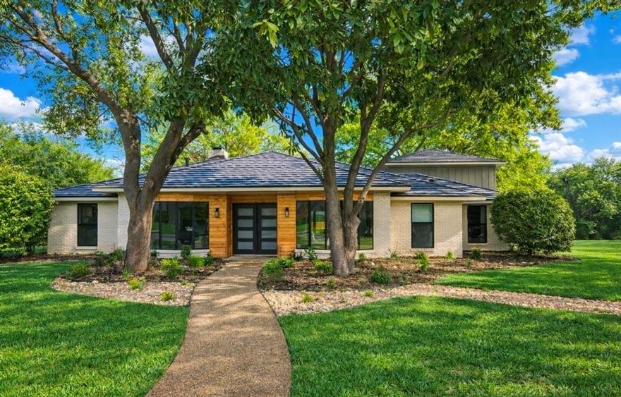 **Back on market due to buyer's funding falling through**
Creekside living meets modern style in this fully renovated corner-lot retreat just steps from Peter Pan Park and minutes from Dallas’ best dining.
Set on an oversized lot with a private wooded path and a hidden bridge to the park, this home offers rare privacy with city convenience. Unwind to the sound of the rolling creek or host friends in a backyard that feels like your own escape. Inside, the open-concept design was made for entertaining. The expansive living area easily accommodates large gatherings, while oversized sliding glass doors create a dramatic indoor-outdoor flow that instantly elevates the space. 
The kitchen delivers both style and function:
Butler’s pantry with butcher block counters
Abundant storage
Dedicated laundry space
Room for a second refrigerator
Breakfast bar with hidden cabinetry
The split-bedroom layout offers versatility — ideal for guests, roommates, or a home office setup. The primary suite is a true retreat, featuring a private fireplace, spa-inspired wet room, and dual oversized walk-in closets. Upstairs, a massive flex space can serve as a media lounge, game room, gym, or fifth bedroom — tailored to your lifestyle.
Sophisticated, flexible, and full of personality — this is creekside living without compromise

**Full renovation includes: New cedar board on board fence, new pvc plumbing under the house, energy
efficient windows, new HVAC upstairs, all materials from floor to
ceiling, top of the line kitchen apppliances, foundation update with
transferable warranty, upgraded security system, and so much more!