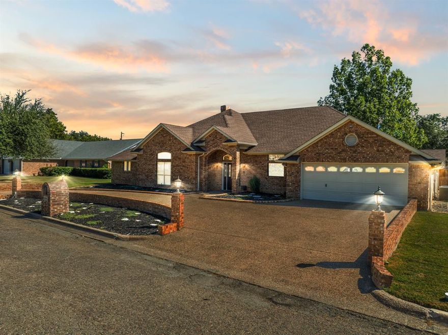 OUR LOSS IS YOUR GAIN - HUGE REDUCTION IN PRICE!! IMMACULATE HOME WITH INLAW SUITE IN MEXIA, TEXAS! This beautiful brick home boasts many, many fine details. Upon entering the front door you instantly see the quality of construction and attention to details. The Living Room is open to the Dining Room and Kitchen and boasts an abundance of natural light from the windows through the Sunroom. Lots of woodwork, trim, gorgeous wood flooring, brick fireplace and spaciousness for large furniture are pluses of the Living Room. The Dining Room is in a rotunda shape and has a custom built in hutch and spectacular chandelier. The Kitchen is plentiful in cabinetry, granite countertops, and plenty of room for 2 cooks to share the space. The Primary Suite is a wonderful retreat for the Owners with ample room for a sitting area. A bonus is a His Bathroom and a Hers Bathroom and a Sauna. Both His and Hers has top line appointments and large walk-in closets which provide ample space for daily routines. The two Secondary bedrooms are a great size for queen or a king sized bed and large dresser. All Secondary Bedrooms have wonderful walk-in closets.  This home has the perfect floorplan of a Kitchenette, Sitting area, Bedroom and bath for the In-Law Suite. The Sunroom stretches across the back of the home and gives a great view to the backyard oasis. The yard is fitted with an inground sprinkler system. Other details of this property are the blown in insulation, floored attic space for storage and easy access with 2 entrances. This quiet neighborhood is located close to Mexia Downtown as well as shopping and restaurants. Mexia is only 45 minutes from Waco, 30 minutes from Corsicana and 1.5 hours from Dallas.