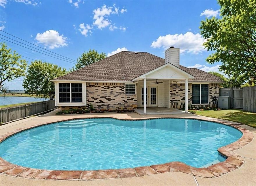 Beautiful single-story brick home located in the desirable River Trails Addition, offering exceptional curb appeal with mature shade trees and a charming drive-up. Step into your own private backyard oasis featuring a sparkling pool—perfect for Texas summers (pool care included)—and a covered patio ideal for outdoor entertaining and weekend BBQs. The home backs to a serene greenbelt, providing added privacy and peaceful views.
Inside, you’ll find a spacious, light-filled layout with a large family room featuring a decorative fireplace that flows seamlessly into the formal dining area—perfect for hosting. The home boasts fresh neutral paint, newer luxury laminate flooring (no carpet), vaulted ceilings, ceiling fans, and 2-inch blinds throughout. The kitchen is both stylish and functional with stainless steel appliances, quartz countertops, white cabinetry, designer backsplash, refrigerator included, and a cozy breakfast nook. Primary suite offers a relaxing retreat with dual vanities, a garden tub, and a medicine cabinet for added storage. Enjoy nearby community amenities including walking trails, a lake, park, and playground—all within walking distance. Conveniently located with easy access to major highways, making commuting to Fort Worth, Arlington, and nearby shopping, dining, and entertainment a breeze.
This is a must-see home and won’t last long!