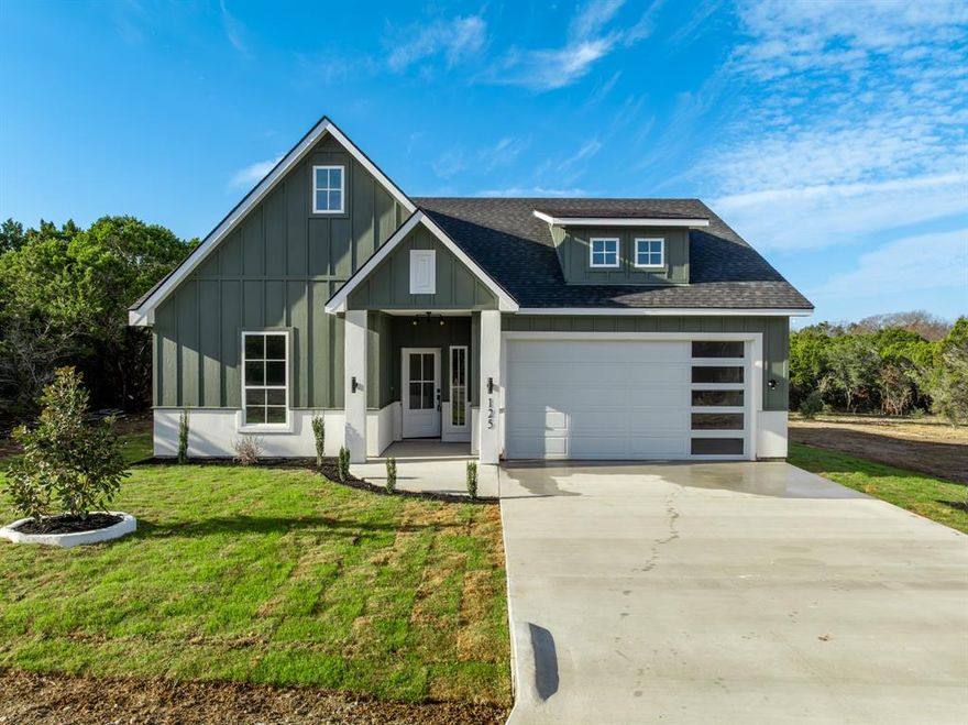 NEW IMPROVED PRICE! Welcome to The Estates — where peaceful living meets thoughtful craftsmanship. This stunning new modern farmhouse includes 3-bedroom, 2-bathrooms, with an upstairs bonus room sits on a beautifully landscaped half-acre lot, offering plenty of room to add a pool, shop, or garden retreat. Located in a quiet community surrounded by nature and visiting wildlife, you’ll love that Lake Whitney is just a short walk or drive away.  Step inside to find vaulted ceilings, white quartz countertops throughout, custom-built tile showers (no inserts!), and high-efficiency spray foam insulation for year-round comfort. Every detail reflects quality — including treated-lumber framing, central vacuum system, wood beams, and built-in customizable night-lights on the first floor. The heart of the home has open concept for entertaining guest. Livingroom comes with fireplace, TV. This home has stainless steel appliances including a refrigerator, spacious kitchen island with quartz countertop, pot filler, and leads to an inviting covered patio and an impressive 160 sq ft outdoor kitchen with sleek black quartz countertops and storage cabinetry, and TV — perfect for entertaining under Texas skies. Additional highlights include Aerobic septic system with spray irrigation, epoxy-coated garage flooring. Spacious yard with endless possibilities. Whether you’re relaxing outdoors, hosting friends, or enjoying a quiet evening at home, this thoughtfully designed property delivers comfort, style, and lasting quality