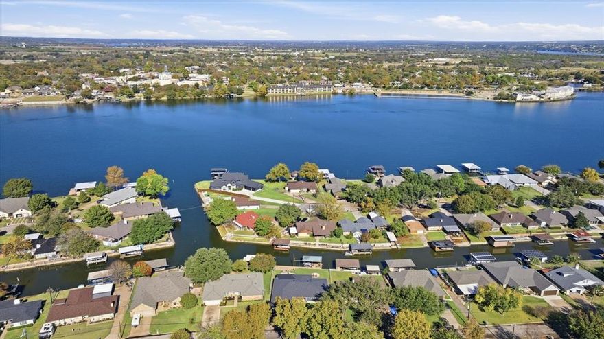 Waterfront home with main-body water views and canal access. This property offers multiple ways to enjoy the lake, including jet ski lifts and a dockside sitting area right on the water.
The backyard features a built-in firepit and hot tub, creating ideal spaces for outdoor living and entertaining. Inside, the home includes a wet bar with access to the backyard, supporting a seamless indoor–outdoor flow.
The kitchen offers abundant storage, a beautiful center island, and generous workspace, making it a standout feature for cooking and gathering. Large windows throughout the home capture the surrounding water views, and the layout provides comfortable living for full-time residents or weekend guests.
Additional highlights include spacious outdoor areas, direct water access for recreation, and the flexibility of no HOA.
This property delivers a complete waterfront lifestyle with desirable amenities and scenic views.