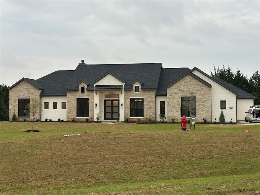 LOCATION LOCATION LOCATION and did I mention all the trees. 4-Bedroom Estate on 1 Acre in Waxahachie, TX – Waxahachie ISD. This stunning One- story home in the highly desirable Waxahachie ISD offers the perfect blend of elegance, comfort, and modern design. Situated on a sprawling 1-acre lot, this 4-bedroom, 3 bathroom estate is thoughtfully designed for both everyday living and grand entertaining. Home was built specifically for a family who had to cancel. Lots of upgrades are now yours to enjoy. Upgrades include things like pre wired for a complete home surround system, whole house generator (generex) is pre wired and ready for the actual machine, 17 seer AC, gun cabinet in master closet, tons of millwork upgrades. The back porch has a fireplace and is 50 feet long. Home is heavily treed but perfect clearing for your pool and cabana already cleared out. Call Danny today to see it.**** this was a custom designed home for a specific family with specific taste. Builder is currently doing some paint and color changes