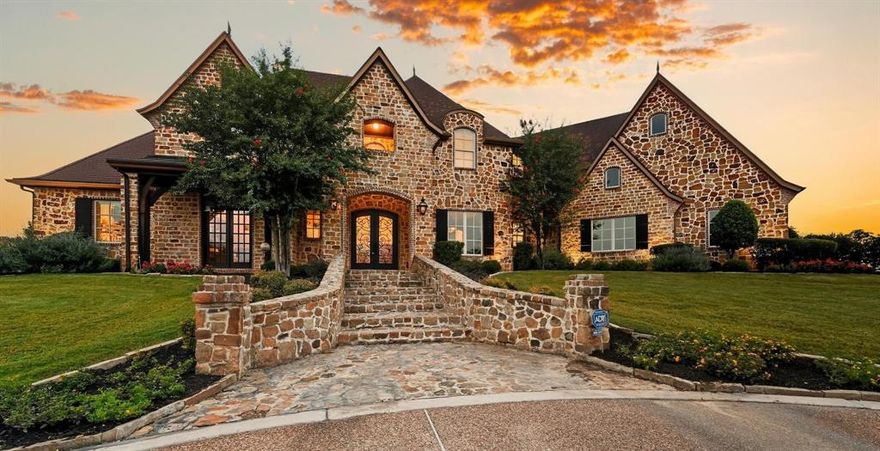 PICTURESQUE 3-ACRE ESTATE WITH A LUSH BACKYARD SANCTUARY, BARN & 4-CAR GARAGE! The foyer welcomes you with a chandelier & flows into a living area with a wall of windows overlooking the backyard & pool. A Texas-style office with Mediterranean flair sits off the foyer, offering French door views of the front acreage. Brick & stone features highlight the inviting feel of the open family room & breakfast area, with a formal dining room for special occasions. Host in the gourmet kitchen featuring high-end appliances, a gas cooktop, center island with a prep sink, bar seating, walk-in pantry, butler’s pantry & a wine room with an Avanti fridge & space for nearly 200 bottles. Pamper yourself in the lavish primary suite showcasing a double tray ceiling, fireplace & a massive walk-in closet with a chest of drawers, plus a spa-like bath offering a jetted tub with stylish columns, a dual-head shower & separate vanities. Upstairs, enjoy a huge game room with a wet bar area, a private media room designed for theater style seating, a balcony with elevated views & three secondary bedrooms. The outdoor elements of this home make it a truly unique find! Drive up from the road appreciating the lush trees & ranch-style fencing that leads to a huge pasture for horses or family exploration. The modern barn with four stalls & a tack room invites horses or any other use on this spectacular property. The backyard is your personal wonderland for quiet time or entertaining, boasting a large saltwater pool with a black stone bottom, an eight-foot deep end, fountain, water feature & spa. A new gas grill & broad space for seating guarantees memories to last a lifetime. Surrounding greenery offers privacy & a getaway from the rest of the world. Fantastic location down the street from Rocky Point Trail, an equestrian trail, with easy access to Lake Grapevine & the popular Northshore Trails featuring 22+ miles for hiking, biking & walking. Click the Virtual Tour link to see the 3D Tour!