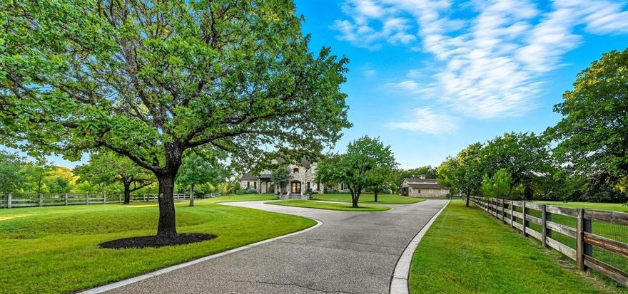 PICTURESQUE 3-ACRE ESTATE WITH A LUSH BACKYARD SANCTUARY, BARN & 4-CAR GARAGE! The foyer welcomes you with a chandelier & flows into a living area with a wall of windows overlooking the backyard & pool. A Texas-style office with Mediterranean flair sits off the foyer, offering French door views of the front acreage. Brick & stone features highlight the inviting feel of the open family room & breakfast area, with a formal dining room for special occasions. Host in the gourmet kitchen featuring high-end appliances, a gas cooktop, center island with a prep sink, bar seating, walk-in pantry, butler’s pantry & a wine room with an Avanti fridge & space for nearly 200 bottles. Pamper yourself in the lavish primary suite showcasing a double tray ceiling, fireplace & a massive walk-in closet with a chest of drawers, plus a spa-like bath offering a jetted tub with stylish columns, a dual-head shower & separate vanities. Upstairs, enjoy a huge game room with a hidden door leading to a hidden room and a wet bar area, a private media room designed for theater style seating, a balcony with elevated views & three secondary bedrooms.  Drive up from the road appreciating the lush trees & ranch-style fencing that leads to a huge pasture for horses or family exploration. The modern barn with four stalls & a tack room invites horses or any other use on this spectacular property. The backyard is your personal wonderland for quiet time or entertaining, boasting a large saltwater pool with a black stone bottom, an eight-foot deep end, fountain, water feature & spa. A new gas grill & broad space for seating guarantees memories to last a lifetime. Surrounding greenery offers privacy & a getaway from the rest of the world. Fantastic location down the street from Rocky Point Trail, an equestrian trail, with easy access to Lake Grapevine & the popular Northshore Trails featuring 22+ miles for hiking, biking & walking. Click the Virtual Tour link to see the 3D Tour!