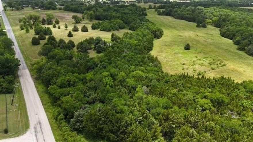 Rare opportunity to own 10 pristine acres in one of Rockwall County’s most desirable areas. Located outside city limits in a serene setting of gently rolling hills, this property offers the perfect blend of peaceful country living and convenient access to urban amenities. Surrounded by luxury estates and zoned to the highly acclaimed Rockwall ISD—specifically Amy Parks-Heath Elementary—this land is ideal for building your dream home or exploring a small, upscale development. The parcel offers wide-open views, mature trees, and natural beauty, making it a stunning canvas for custom construction. With no city taxes and flexible zoning, the possibilities are abundant. Enjoy close proximity to fine dining, boutique shopping, entertainment, and major highways just minutes away. Whether you're looking to build a private estate or capitalize on the area’s continued growth, this exceptional property delivers location, lifestyle, and lasting value.