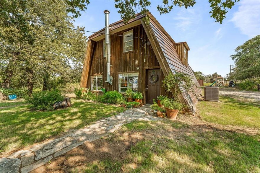 Charming and unique, this A-frame cottage sits on 1.43 acres just 5 minutes from town, offering the perfect blend of convenience and privacy. With road access at both the front and back, the property offers flexibility and is full of possibilities. Inside, you'll find an updated layout with a spacious living room centered around a cozy wood burning stove, a full bath and a dining area that flows into the kitchen. Step out back to enjoy the covered porch overlooking your peaceful acreage. Upstairs features three bedrooms and another full bathroom, with the primary suite boasting its own private balcony for morning coffee or a place to unwind and take in the views. Surrounded by mature landscaping and privacy hedges, the land provides ample outdoor space for gardening, entertaining, or simply enjoying the fresh air. Whether you're looking for a quiet retreat, a family home with character, or a property that combines charm with acreage, this home delivers a truly special opportunity.