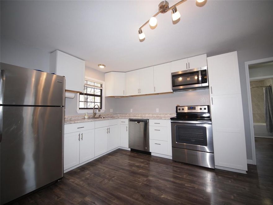 PRICE REDUCED!! Delightful, move-in-ready and recently updated one bedroom, one bathroom, one car detached carport home near Crestview Elementary school including a 13 X 10 BONUS ROOM or FLEX ROOM that could be used as a bedroom with the addition of an armoire or dresser. Modern, solid surface flooring that looks like wood throughout. Recent light gray interior wall paint throughout provides a modern farmhouse vibe. The living room is spacious at 18 X 11 and offers newer windows providing ample natural lighting along with a lighted ceiling fan.  The eat-in-kitchen boasts newer stainless steel appliances including a smooth-surface Whirlpool electric range, built-in Whirlpool microwave, Whirlpool dishwasher, stainless steel sink, white cabinetry with modern hardware, Formica countertops and the refrigerator conveys. Stackable GE washer-dryer combo conveys. Newer electric water heater with a pan and overflow drain line. Super-cute bathroom with a tub-shower combo, 18 inch tile surround, vanity with sink, built-in towel & display shelving and toilet. Lighted ceiling fans and mini-blinds throughout. Central heat & air. Newer composition roof. Storm doors. Covered porches. Oversized backyard with mature shade trees, a wood privacy fence on one side and a chain-link fence on two sides. Metal storage container in the northwest corner of the backyard conveys to the New Owner.  You'll fall in love with this darling, cottage-style home located in an established neighborhood near schools, churches and the post office. Make this your cozy, low maintenance abode or turn-key rental property while it's still available!