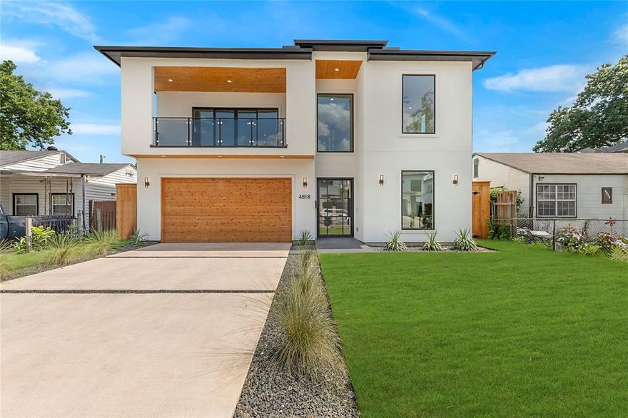 Welcome to 4818 Cowan Avenue in Dallas, an exquisite 5-bedroom, 5-bathroom modern masterpiece spanning 3,743 square feet. Step into a grand living area with soaring 24 ft ceilings and floor-to-ceiling windows that flood the space with natural light. The gourmet kitchen extends to an outdoor kitchen, perfect for al fresco dining and entertaining. A versatile bonus space comes equipped with a wet bar, ideal for gatherings or a cozy retreat. The primary suite is a sanctuary featuring an elegant accent wall, a spacious walk-in closet, and a convenient laundry hookup in the bathroom, while a full laundry room upstairs adds extra convenience. The home also boasts a sophisticated wine wall, a balcony with lovely views, and expansive walk-in closets throughout. The backyard offers ample space for outdoor activities and relaxation, making this home a perfect blend of contemporary design and unmatched comfort in a prime Dallas location.