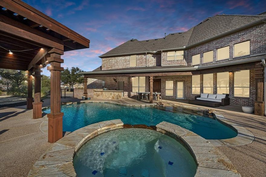 An extraordinary blend of elegance, privacy, and resort-style living awaits! Welcome home to this custom estate situated on over an acre and located in the private gated neighborhood of Estates at Copper Canyon. Over $340K in recent upgrades! From the moment you step inside, you’re greeted by top-to-bottom designer upgrades and refined architectural details throughout. A sweeping grand staircase creates a striking first impression, paired with a private front office and spacious formal dining room. The chef’s eat-in kitchen is a showpiece, featuring custom cabinetry, gas range, double ovens, wine refrigerator and bar, and a custom pantry—perfectly positioned to overlook the main living space. The open-concept floor plan flows into the expansive living room, highlighted by soaring ceiling, grand gas fireplace and dramatic windows framing views of the backyard oasis. Separate downstairs bedroom and bathroom make for the perfect guest quarters or mother-in-law suite. The primary suite is a true private retreat, showcasing stunning tray ceilings, dual vanities, spa-inspired soaking tub, oversized walk-in shower, MASSIVE custom-designed closet, and private access to the backyard. Upstairs offers three additional bedrooms, a spacious game room, and a dedicated theater-style media room for elevated entertaining. Outdoors, indulge in a resort-caliber backyard complete with a beach-entry heated diving pool, expansive outdoor living areas, an extended covered patio, and a separate cabana with fireplace—designed for year-round enjoyment. Completing the home is a 3-car oversized garage with custom cabinetry and epoxy flooring. Ideally located near fantastic shopping, fine dining, and award-winning schools—this remarkable estate offers luxury living at its finest. A rare opportunity not to be missed!