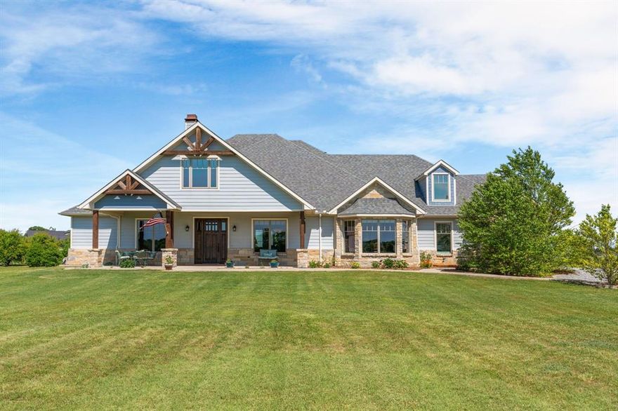 Stunning Custom Built craftsman Estate built in 2018 with Breathtaking Views and a Versatile three bedroom barndominium plus a 1400 square foot workshop! Welcome to your dream property, with two homes on the 2.5 acres. Whether you are looking for guest accommodations, multi generational living, or an income producing opportunity, this second structure offers endless potential. The main residence is a 1.5 story home with 3 bedrooms down and one bedroom up with full bath. The barndo is a residence all of its own with 3 bedrooms and 3 bathrooms. This meticulously craftsman style home offers the perfect blend of luxury, functionality all set against panoramic sunrise and sunset views with an expansive front porch and in back, an outdoor living area with kitchen and stone fireplace.  The main residence is an energy efficient 4 bedroom, 4 bath masterpiece, thoughtfully constructed with spray foam insulation and low E windows to ensure year round comfort and savings. The interior has custom finishes throughout, from warm woodwork including beams, custom mantle, extensive millwork throughout the home to designer lighting. The heart of the home is a chef's dream kitchen, equipped with a gas range, double ovens, convection microwave, commercial ice maker in bar, & built in coffee maker in a spacious chef's pantry with a serving bar. The island is large with storage. Handsome soapstone countertops in kitchen match the surround to the fireplace. The primary bath is ultra luxurious with a copper nickel freestanding soaking tub, custom cabinetry, granite counter tops, lovely walk in shower with 3 body sprays. Adding tremendous value and versatility, the property also includes a separate 1400 square foot barndo 1400 square ft. workshop.  Don't miss your chance to own this one of a kind estate that perfectly balances elegance, comfort and practicality. Immaculate! See supplements for list of features. This home also has a chicken coup & raised container gardens along w fruit trees.