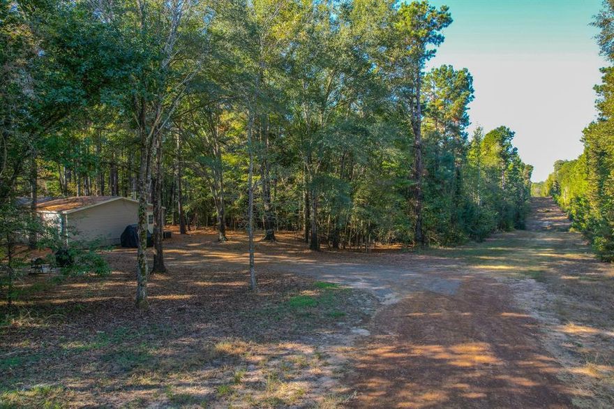 Welcome to this beautiful and secluded 53-acre property offering the perfect blend of comfort, recreation, and natural beauty. The land is heavily wooded with a healthy mix of hardwood and pine timber, providing both shade and privacy, as well as excellent wildlife habitat. Signs of whitetail deer and other native game are abundant, making this an ideal retreat for hunting and outdoor enjoyment.

A small pond and a clear water spring enhance the property’s natural charm—offering the potential to expand into a stunning 5-acre lake with the right dam improvements. The land also features an established trail system for easy access and four-wheeler riding throughout the acreage.
The 32’x76’ mobile home sits tucked within the trees and has been very well maintained. With an open floor plan, this 4-bedroom, 2-bath home features quality finishes, spacious living areas, and a large master suite complete with walk-in closet and private bath. Whether used as a full-time residence or a weekend getaway, this property offers the peace and privacy of the country with all the modern comfort you need.

Call today to setup your own showing!