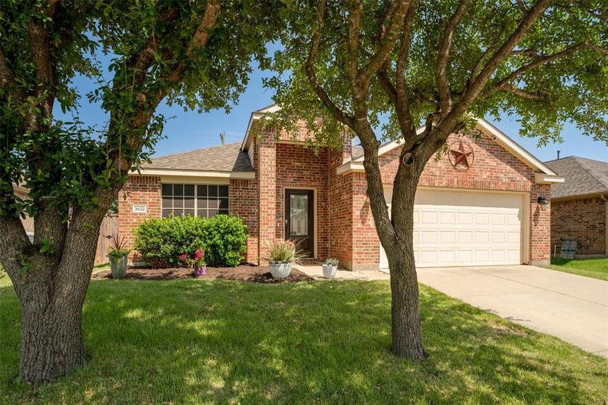 Nestled beneath a canopy of mature shade trees in the sought-after community of Melissa, Texas, this exquisitely maintained all-brick residence delivers a rare combination of warmth, elegance, and thoughtfully curated design. From the moment you arrive, the home's striking curb appeal, lush landscaping, designer container gardens, and a classic brick facade adorned with a traditional Texas star sets the tone.
The home unfolds into an expansive open-concept floor plan where soaring vaulted ceilings, premium flooring, and an abundance of natural light define every space. Just off the entry foyer, a versatile front room with elegant architectural detailing serves beautifully as a private home office or study — currently utilized as an additional bedroom, offering the flexibility today's buyers demand. At the heart of the home, the dramatic great room commands attention with a breathtaking floor-to-ceiling stacked-stone fireplace — a masterwork of hand-laid grey ledgestone that serves as the undisputed architectural centerpiece of the home. The gourmet chef's kitchen impresses with quartz countertops, a full-height subway tile backsplash, shaker-style grey cabinetry, professional gas range, and a sweeping peninsula that opens seamlessly to the living area, perfect for both casual mornings and refined entertaining.
The primary suite is a true owner's retreat featuring an oversized walk-in wardrobe, a spa-inspired ensuite complete with a dual quartz vanity, matte black fixtures, deep soaking tub, and glass-enclosed walk-in shower. Secondary bedrooms are generously sized and full of personality, including a mid-century modern inspired bonus room that functions equally well as a media lounge or formal dining setting.
Outside, enjoy an East facing shaded backyard to escape the Texas heat.   
Meticulously maintained move-in ready pet and smoke free home.