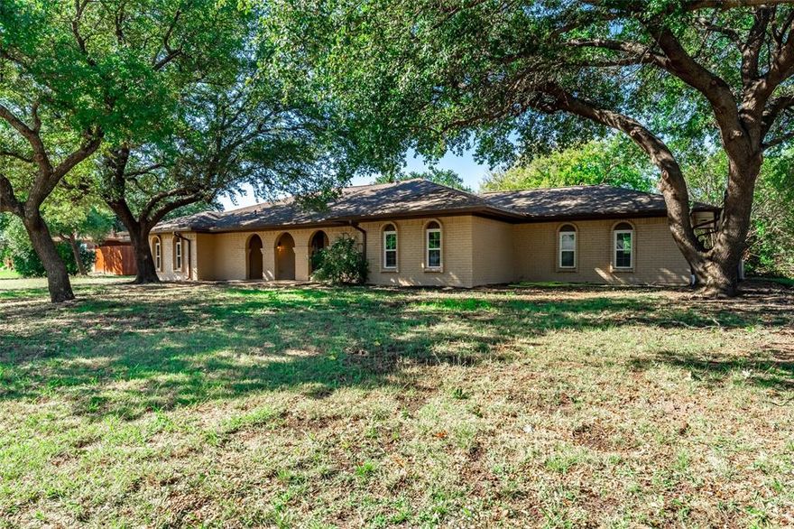 MUST SEE!! You will love this elegant, FULLY REMODELED home on nearly one acre. NO HOA. Home was gutted to the studs in 2022-23 & features new windows, HVAC, water heater, appliances, lighting, fixtures, finishes & more. Chef's kitchen boasts SS appliances, quartz counters, herringbone backsplash, & kitchen island. The expansive living room features a gorgeous stone, wood-burning fireplace & vaulted ceilings with exquisite wood beams. A versatile flex room serves as an ideal home office space. The primary suite is a luxurious retreat with tray ceilings, sitting area, walk-in closet, & ensuite bath with separate vanities, soaking tub, & quartz counters. Three additional bedrooms with walk-in closets provide ample space. The property includes two more full baths, one with a beautiful open shower, & marble flooring in select areas. Outside, enjoy a three-car garage, a huge backyard, covered patio, and brick storage building! Conveniently located close to Dallas just off Collins & Hwy 80.