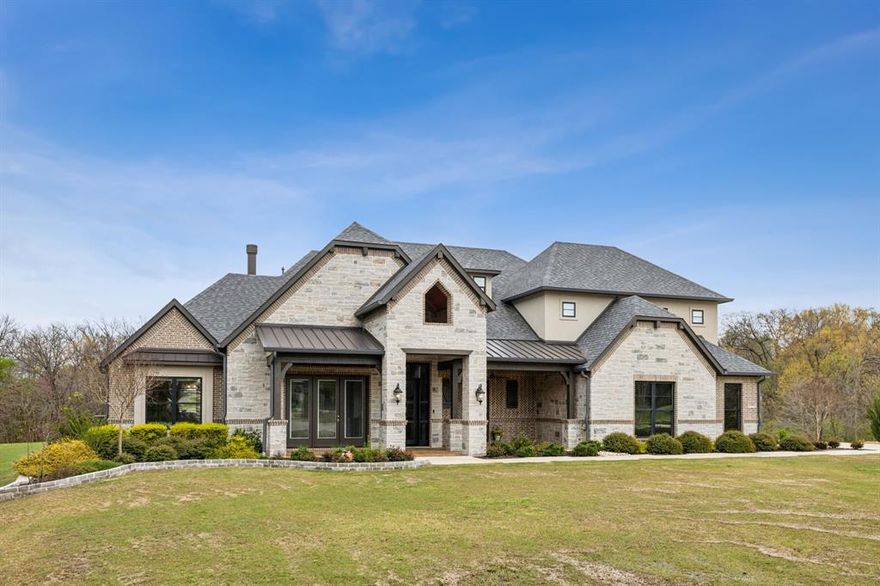 Located in a newer gated Stonebridge Ranch community, this is a rare opportunity to own an almost new true custom home situated on a .9 acre double creek, greenbelt, cul de sac lot.  Ideal for any buyer looking for privacy and quality with 3 spacious bedrooms and a study down plus a 4th bedroom and game room up.  This masterpiece provides captivating tree lined views with floor to ceiling windows, custom ceiling treatments, wood flooring throughout, and an endless list of features to please the most discerning buyer.  Gourmet kitchen features an induction cooktop, a built-in refrigerator, California island, leathered Brazilian marble countertops, wine refrigerator, large pantry, and access to front outdoor dining area. Roomy breakfast nook is full of light, with walls of windows heightened by a stunning chandelier. The inviting living room is anchored by a gorgeous hearth stone woodburning fireplace.  Enjoy the tranquil resort style backyard space with an outdoor living and kitchen that is ideal for entertaining. The primary suite is sublime with a true spa like bathroom with enclosed wet room plus his and hers closets with built ins. Foam encased walk out attic with approximately 2500 sq ft of floored storage.  Adding additional square footage is easily doable if desired. If you are a golfer, you are minutes to PGA, TPC, Pete Dye, and The Hills courses.  Such an amazing location as you are tucked in but a stone’s throw from premier destinations like the The Star, Legacy West, Watters Creek, Highway 121 & 75, and Dallas North Tollway. A few other features worth noting are a whole house water filtration system and water softener, an April aire humidity control unit, Reme Halo air purifiers, dual tankless water heaters, a generator panel that covers the essentials. Some furnishings are available for purchase.