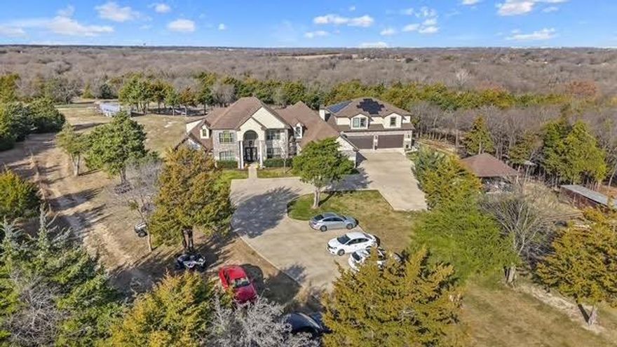 FEEL LIKE YOU'RE ON VACATION... IN YOUR OWN HOUSE!!  This SECLUDED OASIS ON 11.9 ACRES is tucked away ONLY 17 MINUTES to DOWNTOWN DALLAS.  The asking price is no typo.  Views of the Dallas skyline with Oceans of light; 10,500sq ft under roof, 7 massive bedrooms, 5.5 baths, covered parking for 6 cars!  Designed to perfection where living comes easy & ENTERTAINING HUNDREDS is effortless.  Professional grade chef's kitchen fully equipped for large gatherings. The owner's wing is tucked away with an expansive bathroom and closet space for days.  The covered, enclosed and heated patio is nearly 1600sq ft!!!  BRAND NEW oversized 4 car garage with a 2 bedroom apt on top, separate entrance!  You've never seen a MAN CAVE AS BIG AS THIS!  Speaking of big...the pool can be seen from outer space!!!  OF COURSE the outdoor kitchen is designed for hosting hundreds.  The balcony is nearly 20 yards long where you can see 2 counties!  FULLY FOAM INSULATED ROOF & WALLS.  5 mins to I35E and I20, 29 mins to AT&T Stadium & Globe Life Field, 26 mins to Love Field, 37 mins to DFW.  AG EXEMPT.  511 S Bluegrove on 2 acres next door is also available.