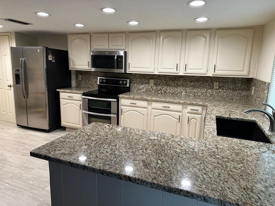 Remodeled Energy efficient 3 Bdrm, 2 bath home features all new stainless steel kitchen appliances, bonus stainless steel refrigerator freezer. Recessed Lighting in Kitchen and utility area. Extensive granite countertops.Custom tile flooring. Gorgeous hardwood flooring throughout. Open floor plan features large Den, wood burning fireplace, built-in bookshelves. Spacious living and Dining rooms. Energy efficient windows with custom window treatments. Updated bathrooms plus 2 car rear entry garage features finished out walls and ceiling. Private entrance from Garage into Master Bedroom. Stained cedar fence on this oversized corner lot. All yard areas are totally sprinklered. Trane HVAC system and almost new water heater. All interior and exterior doors have been replaced with six panel doors and antique brass locks. Paint in excellent condition. Large covered patio, security outdoor lighting. Newish timberline roof complete with gutters and lifetime roof warranty. Low, low utility bills.