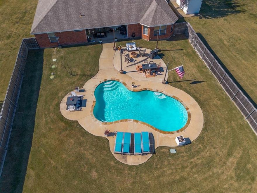 Where else can you find a modern traditional home with an in-ground pool on acreage?  Look no further!  This amazing updated open concept home features 4 large split bedrooms for privacy, 3 full baths, one room could be used as a mother in law suite, den could be office or game room, large updated kitchen with ample cabinets, quartz, backsplash, appliances, island with real butcher block and electric, and breakfast bar which opens to large living area with corner floor to ceiling brick fireplace.  Enjoy year round comfort with a new HVAC system in 2024, hardwood flooring throughout, and drought tolerant landscaping for easy maintenance.  The backyard is your private retreat featuring an oversized in-ground pool, covered patio, sided wood fence, loads of playing areas, and open space behind for that true country feeling. 3 car garage and extra parking space, keyless entry, and a vivant camera security system included making this home the total package.  Come fast and make this home yours!