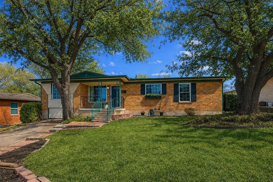 Welcome to this bright and inviting home in the vibrant Forest Oaks neighborhood of East Dallas, where natural light, warm hardwood floors, and an open layout create a space that feels both comfortable and full of possibility. The main living, dining, and kitchen areas flow together easily, making everyday living and entertaining feel effortless. Three bedrooms and a full bath are tucked along the south side of the home, offering a sense of privacy from the main living spaces. Just beyond the living room, a spacious flex room adds incredible versatility with plumbing access already in place. This flexible area can easily serve as a second living space, home office, playroom, or guest retreat, with the potential to create a large split primary suite. A rendering showing the space reimagined with an added half bath is available at the transaction desk. Step outside to a large backyard that offers a true blank canvas for outdoor living, gardening, or future landscaping projects. A pergola creates a natural spot for relaxing or entertaining, and the yard is supported by a sprinkler system. A rear carport provides covered parking. Updates include gas range (2026), dishwasher (2022), microwave (2023), and fans and light fixtures. Bathroom refreshed with painted cabinets, new flooring, and baseboards. Enjoy an unbeatable East Dallas lifestyle just a short walk from Saint Francis Park and only minutes from White Rock Lake, the Dallas Arboretum, Casa Linda Shopping Center, popular dining spots like Smoky Rose, and miles of nearby trail systems. Zoned to Alex Sanger Preparatory.