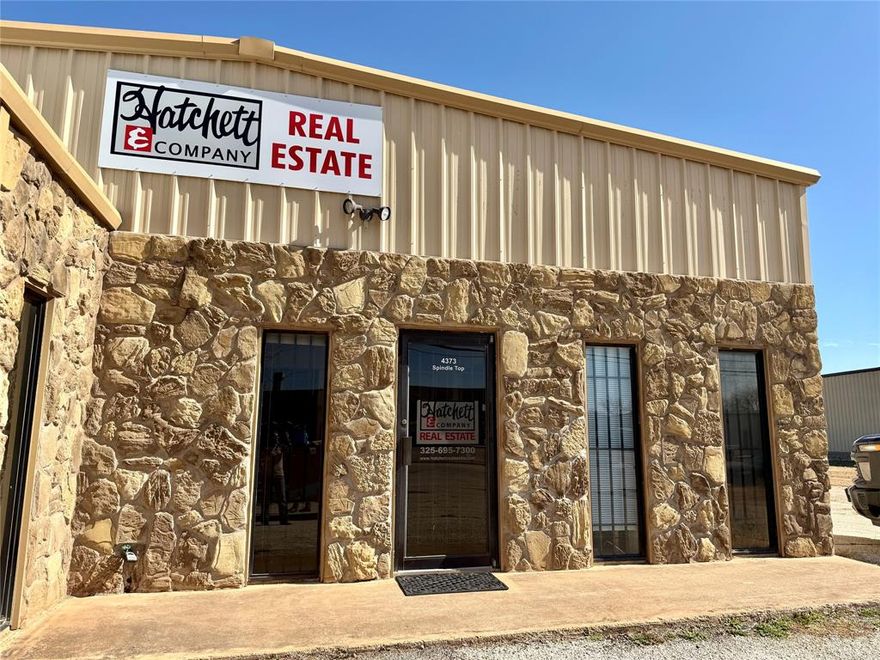Owner-Agent. Updated office space conveniently located in Southeast Abilene! This metal and rock office building with metal roof and slab foundation sits on a double lot with part of the lot paved for parking. 6 Private office spaces plus a reception area that could be a 7th office, very large conference room with magnetic walls making it easy to organize and keep up with large projects, maps, plans, or diagrams. Separate men's and women's restrooms, supply room, and extra decked attic storage. Drop box installed in back door. Central heat and air and a kitchenette area make this office building move in ready for any growing business. This building has it all as well as potential for adding on, fencing, or adding warehouse storage behind or to the south depending on what type of business you have or intend to create. Bring your offers and ideas!