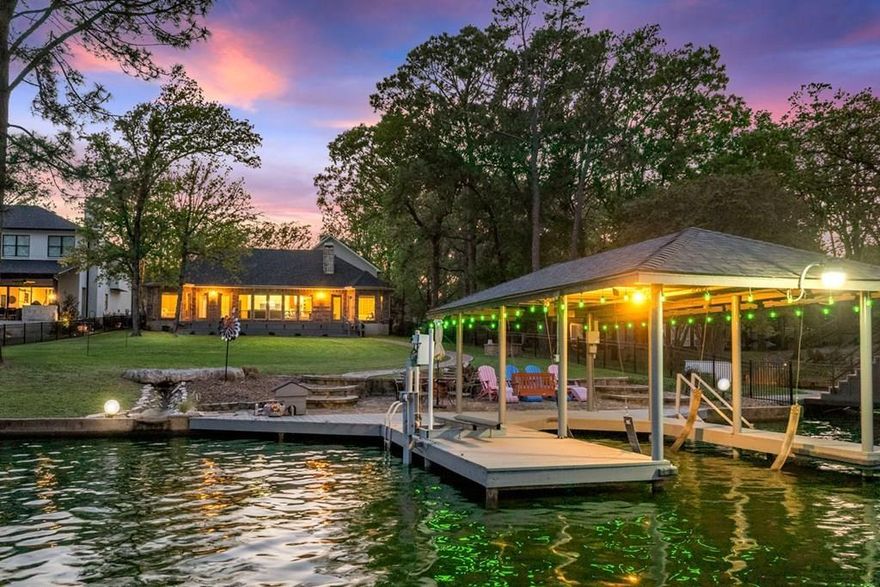 This exquisite executive residence is nestled just off the shores of Cedar Creek Lake, seamlessly combining tranquil natural beauty with modern amenities for an unparalleled living experience. Free from HOA fees, you can savor your morning coffee on the back porch while admiring the breathtaking views or take a leisurely stroll along the stone path through mature trees to your private dock, which boasts over 89 feet of water frontage. The home features solid cedar beams, scored concrete floors, granite countertops, and custom cabinets with slide-out shelves. A wall of windows and a stunning stone fireplace provide panoramic lake views, making this home ideal for entertaining. The open floor plan includes three bedrooms and two and a half bathrooms in the main house, complemented by a guest suite that can accommodate two additional bedrooms, a full bathroom, and a versatile bonus room—offering a total of over 3,054 square feet of living space, perfect for a lakeside retreat. Additional amenities include a spacious three-car garage with a workshop area and a generator transfer switch. Recent updates in 2024 include a new roof, HVAC system, fresh paint, new carpet, and a remodeled primary bathroom. The foundation is reinforced with 12-foot deep pilings, with specifications available on-site. Enjoy sunset views from the back porch and take advantage of the boat house equipped with a power lift for your boat and jet skis. The home is ideally positioned just off open water in a protected cove, perfect for swimming and kayaking. The property also features meticulously maintained landscaping and a lake pump. Seize this opportunity for the ultimate lakeside escape, located in one of the most coveted areas on Cedar Creek Lake.