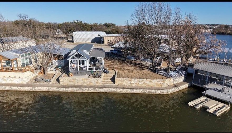 Have you ever wondered what a true tiny home looks like on a beautiful lake setting? Can be a full time home, or makes an incredible weekend place for friends and family to gather. Looking for a rental investment? This could be the one. Enjoy your morning coffee on the oversized deck or evening wine with friends while watching the sunset across the lake. Oversized lot the size of a double lot with plenty of grass area to enjoy or fence in for a pet. ! Like to fish? Its possible right off the porch deck! Only 2 years young with total utilities rarely over $130 monthly!. Property taxes only $1,300 yearly if a senior and homestead exempt! HOA $259 yearly! Short term rentals need to be at least 6 months in length. 25 min to Fort Worth. 60 min to DFW Airport. A double carport protects your vehicles. Completely self contained, two mini splits, AND a loft with a king bed and large TV. Washer and Dryer. Loft with king size bed and tv on second floor. Kitchen and bathroom with bedroom on the first floor.  Over $20K in upgrades to this high end Platinum tiny home made right here in Malakoff, TX. Large wrap around deck with a built in storage shed. Plenty of room for a golf cart. Gorgeous sunsets and a very quiet peaceful cul-de-sac setting. Guest parking spaces for visitors.  Walk to the famous Granbury Square or even the local beach. All amenities within 5 minutes driving.