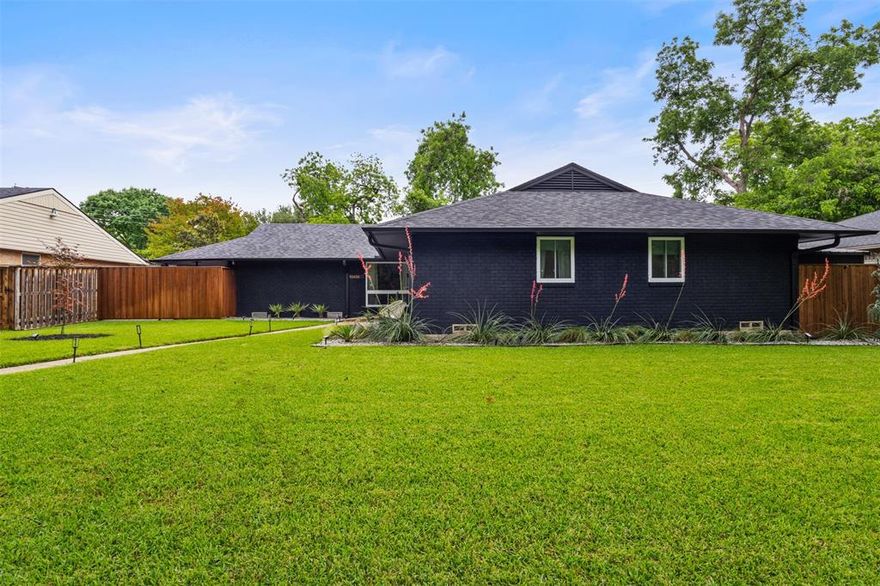 Beautifully renovated by its thoughtful current owners, this single-story mid-century modern home blends timeless style with modern comfort. The open, light filled floorplan is designed for today's living, featuring 3 bedrooms 2 full baths, 2 living areas and an office. The main living area blends effortlessly into a sleek, updated kitchen and out a wall of sliding glass doors to an oversized patio overlooking a serene backyard retreat. Every detail has been meticulously updated, from core systems to refined design details. The chef's kitchen is a true showpiece equipped with GE Cafe appliances, custom cabinetry and striking quartzite countertops. Enjoy you morning coffee, or afternoon cocktail with friends from the elevated wet bar. Serene primary bedroom and bath, features a walk-in shower and upgraded fixtures. Second bathroom features custom cabinetry, double vanities and curated designer materials and finishes. Laundry-mud room accesses the backyard, garage and carport. Other points of interest, exterior brick is stained verses painted, 8 ft stock tank with full filtration system and a Briggs & Stratton full home generator. Walk or bike to White Rock Lake and the area's best coffee shops and restaurants and feeds into exemplary Hexter Elementary School.