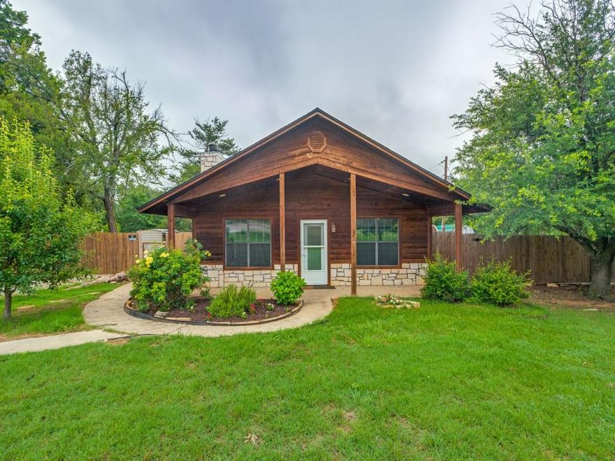 Built in 2000, this charming rustic cabin is tucked away in a wooded area with 1.08 acres of land and trees. The floor plan is an open layout with an inviting wood burning fireplace and 1590 square feet of living space. Adjacent to the living room is a large open kitchen and dining area. It features a kitchen island, with stonework matching the fireplace, and provides barstool seating and extra storage space. There are three bedrooms, and two full-sized bathrooms. The master bathroom comes with a working jacuzzi tub. The roof was replaced in 2021 with 30-year shingles and is still under warranty. The inside and outside HVAC unit was upgraded in 2017.


The spacious land has a wide gravel driveway. It has a partial wooden fence and six-foot no-climb wire on one side. There are two apple trees, two pear trees, and two persimmon trees among the numerous shade trees in the front and back yards, and two raised garden beds. This property also includes three outbuildings. One building can be used for storage or a small workshop and has a lean-to, for your yard machines and or outdoor gardening equipment. The second building features two large double doors, two lofts, and has partially completed insulation and electricity. The third building is a metal tin storage building. There is also a chicken coop, with ventilation, a large entry door, large nesting boxes and a fenced courtyard ready for chickens. The home is within Cooke County and a short drive from US Highway 82, near Callisburg, Texas. The buyer will be responsible for verifying all information.