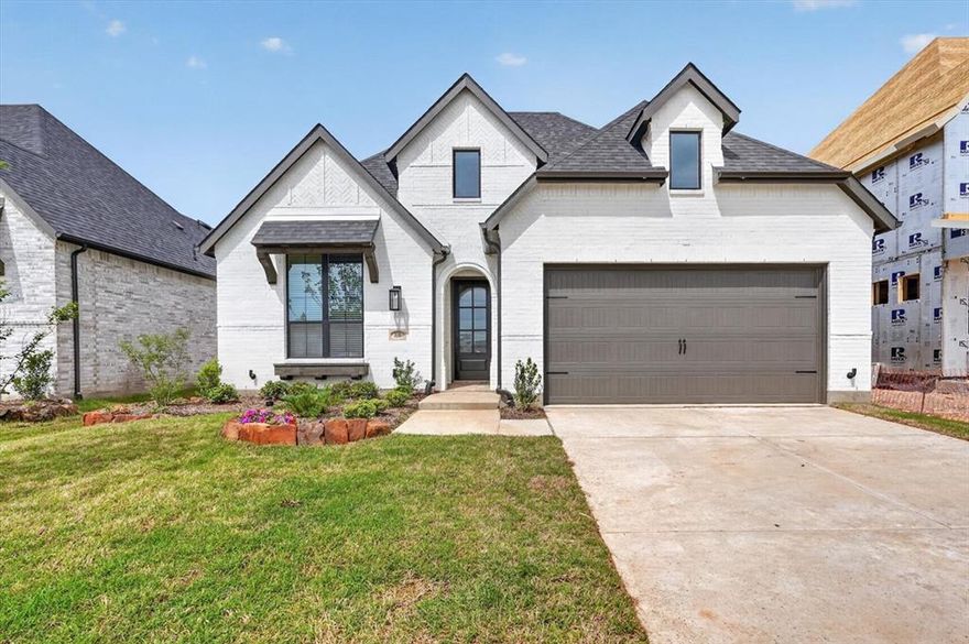 Elevation P, full bath #3 in lieu storage, optional primary bay window, extended outdoor living area & rear brick options. Primary bath freestanding tub with separate shower. Additional 5in depth added to garage! Painted white brick, upgraded black windows & black onyx shingles. Gorgeous tile fireplace extended to ceiling!