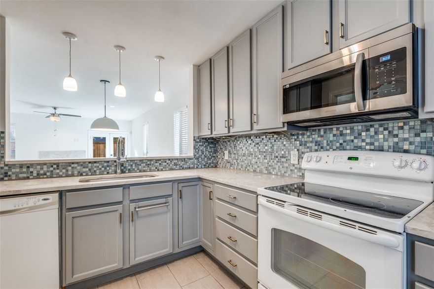 Step into modern comfort with this beautifully updated, multi-level condo featuring 2 bedrooms and 2.5 bathrooms. The open-concept layout offers a bright and airy feel, complemented by sleek contemporary finishes throughout. The stylish kitchen flows seamlessly into the dining and living area, perfect for everyday living and entertaining. Enjoy the outdoors on your private patio, an inviting space for morning coffee or evening relaxation. Upstairs you will find two spacious bedrooms, each with their own en-suite bath with walk-in closets, offering privacy and convenience. The large laundry room upstairs is a huge added benefit. Located in a secure gated community, two refreshing pools to enjoy, and an assigned carport space. This place has it all!  Close to downtown, NorthPark Mall, White Rock Lake, dog park and bike trails.