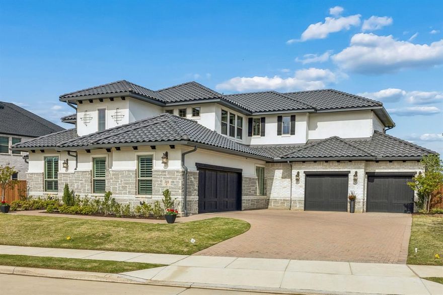 Located in the highly sought-after, newly developed Star Trail community, this well-designed cottage-style home offers a comfortable blend of space, function, and thoughtful upgrades. Featuring 5 bedrooms, 4.5 bathrooms, a dedicated media room, and a spacious game room, the layout provides flexibility for everyday living and entertaining. The exterior showcases a durable tile roof, stone accents, and a welcoming entry. Inside, natural light fills the open-concept living areas, complemented by high ceilings, clean architectural lines, and plantation shutters throughout. The kitchen is designed for both function and style, featuring a large island, ample cabinetry, double ovens, wine cooler, and a Sub-Zero refrigerator. An additional secondary kitchen is already plumbed, offering the opportunity to customize to your needs. The primary suite offers a private retreat with a spa-style bath, soaking tub, separate walk-in shower with marble tile extending to the ceiling, dual vanities, and a custom closet with an additional storage section ideal for luggage or seasonal items. With two bedrooms conveniently located on the first floor, this layout provides added flexibility for guests or multi-generational living. Secondary bedrooms are well-sized with access to full bathrooms. Flooring includes wood-style flooring in main living areas with carpet in select spaces for comfort. A 4-car garage provides ample parking and storage. A functional and inviting home with thoughtful upgrades, located in a growing community.