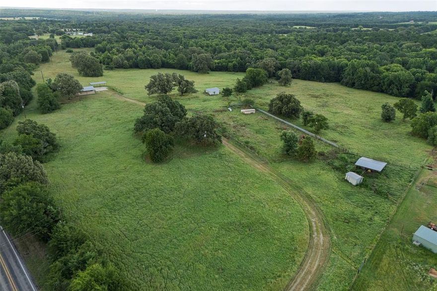 40 Acres in Lindale, TX - Horse & Cattle Ready - Peaceful Country Living

Located in the highly desirable Lindale area of Smith County, this scenic 40-acre property offers a beautiful mix of open pasture and mature hardwood trees, creating a peaceful and inviting country setting. A long, private driveway leads you through the trees and up to a welcoming homesite—ideal for anyone looking to enjoy the rural lifestyle with space, privacy, and potential.

The centerpiece of the property is a 2008-built, 1,680 sq ft manufactured home featuring central heat and air, a concrete slab foundation, and covered porches on both the front and back—perfect for relaxing and soaking in the views. A large carport beside the home provides convenient covered parking.

This land is set up for livestock with fencing and cross-fencing for cattle or horses, multiple water spigots in the pastures, and an open pole barn with 2 foaling-size stalls and automatic waterers. The old arena still has roping boxes and a chute in place—just needs some cleanup to be fully functional again. With a little attention, this property could easily be restored into a working ranch or horse property.

Located just 6 miles from I-20, 11 miles from downtown Lindale, 20 miles to Tyler, and about 80 miles from Dallas, the property offers the peace and quiet of the country with convenient access to town and major highways.

Whether you’re looking for a hobby farm, equestrian setup, or a peaceful homestead with room to grow, this East Texas gem is ready for its next chapter.