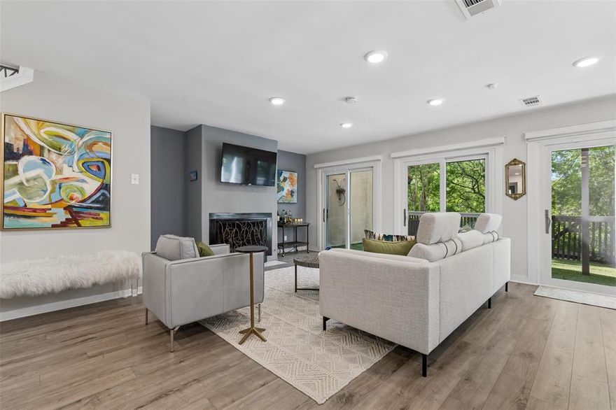 Set within a serene tree-lined enclave in the heart of Lake Highlands, this fully reimagined townhome offers a sophisticated blend of modern design and tranquil natural surroundings. Ideally positioned near Royal and Skillman, the home combines peaceful privacy with effortless access to the area’s best dining, shopping and commuter routes. A dramatic wall of windows and sliding glass doors defines the main living space, flooding the home with natural light and framing the lush greenbelt and creek views, creating a rare treehouse-like retreat. The open-concept design flows seamlessly from living to dining to kitchen curated for both elevated entertaining and everyday ease. The kitchen is equal parts functional and striking featuring quartz countertops, extensive cabinetry and recently updated appliances (2023) accented by thoughtfully selected designer lighting. Upstairs the primary suite is a true sanctuary complete with dual walk-in closets and a spa-inspired bath offering a soaking tub, oversized glass-enclosed shower and double vanities designed for both comfort and indulgence. Each secondary bedroom includes its own en suite bath delivering privacy and flexibility for guests or family. Recent enhancements include luxury vinyl plank flooring throughout, updated lighting, gutters and low-maintenance turf in both the front and rear outdoor spaces creating a lock-and-leave lifestyle without compromise. A spacious two-car garage adds convenience and extra storage. Residents enjoy access to a thoughtfully maintained community featuring a pool, tennis and basketball courts, clubhouse and scenic walking paths that wind along the adjacent greenbelt. Refined, turnkey and surrounded by nature—this is Lake Highlands living at its most elevated.