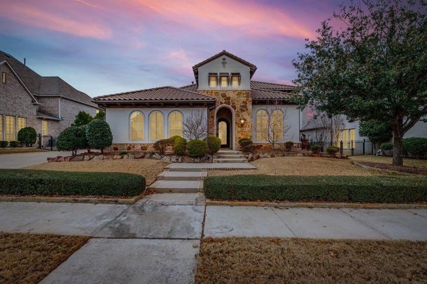 Tucked within the prestigious gated community of Newman Village in Frisco, this exceptional estate offers timeless architecture, luxurious finishes, and refined comfort throughout. Newman Village is primely located only minutes from the PGA Frisco and includes amenities such as but not limited to a gated and guarded entrance, pickleball, tennis, clubhouse, and playgrounds. A striking stone and brick façade creates an unforgettable first impression, complemented by manicured landscaping and elegant exterior lighting. Inside, soaring ceilings, rich hardwood floors, and expansive windows fill the home with natural light while highlighting thoughtful craftsmanship throughout. The grand foyer opens to a sweeping staircase and flows seamlessly into formal living and dining spaces designed for everyday living and entertaining. The gourmet kitchen is a true centerpiece featuring professional grade appliances, custom cabinetry, an oversized island, and abundant storage, all overlooking a spacious family room anchored by a statement fireplace. A private study provides an ideal work from home setting, while the serene primary suite offers a spa inspired bath with dual vanities, a soaking tub, an oversized walk in shower, and a boutique style closet. Generously sized secondary bedrooms include well appointed baths ensuring comfort and privacy throughout. The home also features a dedicated media room, a spacious game room upstairs, a sauna, and a workout area with fitness equipment. Outdoors, the backyard retreat offers a covered patio and ample green space for year round enjoyment. A slate roof, quality construction, and meticulous maintenance reflect pride of ownership and lasting value. Located within highly rated Frisco Independent School District and close to premier shopping, dining, and entertainment, this residence offers the opportunity to own a distinctive luxury home in one of North Texas’s most sought after neighborhoods.