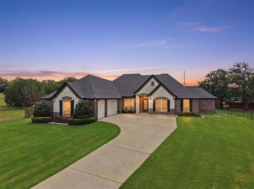 Located in the gated community of DeCordova Ranch, this custom 4-bedroom, 3-bath home delivers 3,118 sq ft of upscale living paired with a backyard designed to be the destination. With approximately 24,000 sq ft of turf, this outdoor space goes far beyond a typical backyard featuring a pool, putting green, inground trampoline, expansive recreation space, covered patio with gas hookup for grilling, and room to entertain on a level rarely found in neighborhood living.

Inside, handscraped wood flooring, granite throughout, coffered and vaulted ceilings, and custom built-ins create a warm luxury feel. The living room is anchored by a striking floor-to-ceiling rock fireplace with gas logs and built-in cabinetry.

The kitchen was built for gathering with a gas range, pot filler, double ovens, oversized island with built-in wine storage, abundant cabinetry, and generous prep space for entertaining.

The private primary suite offers a spacious retreat featuring dual vanities, jetted soaking tub, walk-in shower, and an oversized custom closet with built-ins and three levels of hanging rods. A dedicated office provides flexibility for working from home while additional bedrooms offer comfortable accommodations for family and guests.

Built in 2015 and tucked inside one of Granbury’s desirable gated communities, this property combines custom finishes with an outdoor experience that feels more like a private resort than a backyard. Whether hosting pool parties, practicing your short game, grilling with friends, or simply enjoying the open space, this home was designed to be lived in.