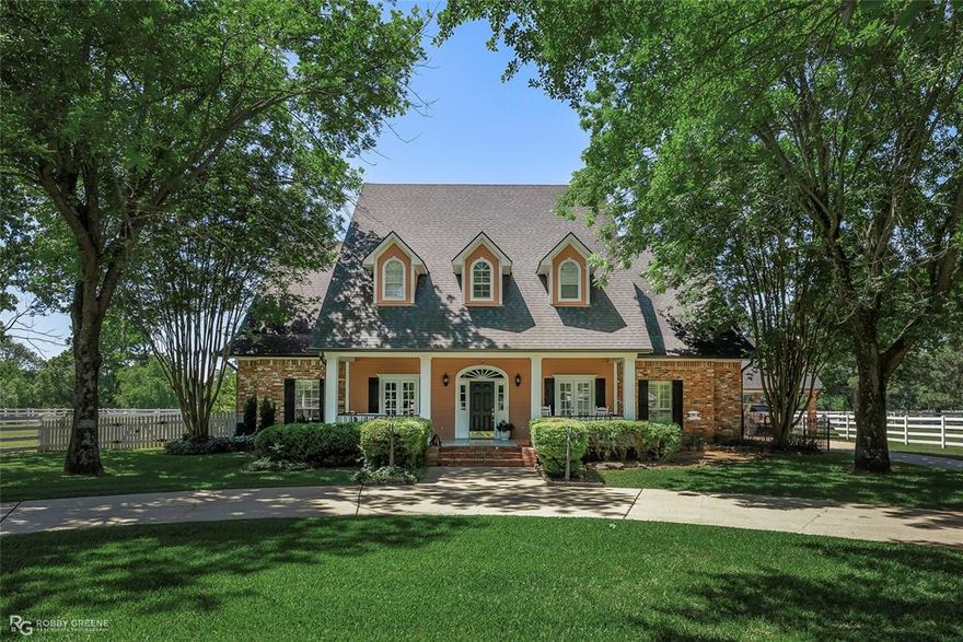 Nestled on 3.1 picturesque acres in the heart of North Bossier, this stunning 5-bedroom, 4.5-bath estate blends timeless southern elegance with resort-style amenities. A circular drive framed by mature oaks welcomes you to a home that exudes curb appeal and classic charm. Inside, over 4,450 square feet of refined living space unfolds, warm hardwood floors, exposed brick accents, and soaring ceilings create a perfect harmony of comfort and sophistication. The gourmet kitchen is a showpiece with custom cabinetry, granite counters, statement lighting, and an inviting open flow into the dining and living areas. A towering brick fireplace anchors the great room, complemented by dramatic double-height windows and rich blue tones that make every detail pop. Each room is generously sized and the home office offers convenient ability to work from home Movie nights reach cinematic perfection in your private theater room, complete with tiered red recliners and surround sound. The spacious primary suite offers a serene retreat with spa-like bath amenities, while additional bedrooms ensure ample space for family and guests. Step outside to a backyard oasis that will leave you breathless, a sparkling in-ground pool, outdoor kitchen and bar beneath a cedar pergola, and lush, manicured landscaping that feels like a resort getaway. Follow the brick pathway to the horse stables and fenced pastures, perfectly suited for equestrian enthusiasts or anyone dreaming of wide-open space. There’s even a large stable and barn, ideal for hobbies, livestock, or storage. The covered carport, expansive patios, and tranquil country views complete the picture an entertainer’s dream and a family’s forever home all in one. All this just minutes from I-220, shopping, and award-winning schools, yet worlds away from the everyday. Don't miss your chance to call 1171 Wemple Road home, where elegance meets country living, and every day feels like a retreat. Call today for your private showing!