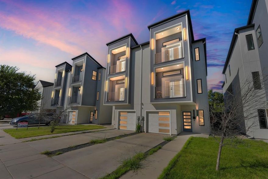 Luxurious, contemporary, 4 bedrooms, 4.5 baths with 2 car tandem garage. Incredible natural lighting with a perfect blend of warmth and modern luxe design. First floor layout: Garage, wood look tile on first floor, secondary bedroom with full bath. Bedroom opens to patio and backyard. Second floor: Going to up to second floor wood floors on stairs and through out 2nd floor open living concept. Kitchen with sleek, European-style cabinets, quartz countertops with breakfast bar. Refrigerator and double oven. Living room with Downtown views, fireplace, balcony. Secondary bedroom and full bath also located on the 2nd floor. Third floor: Third floor wood floor with spacious master bedroom views of Downtown and the setting sun. Gorgeous master bath. Additional bedroom with full bathroom. Laundry room and stackable washer and dryer. Close to Bishop Arts, Downtown, Sylvan 30 and Trinity Groves.