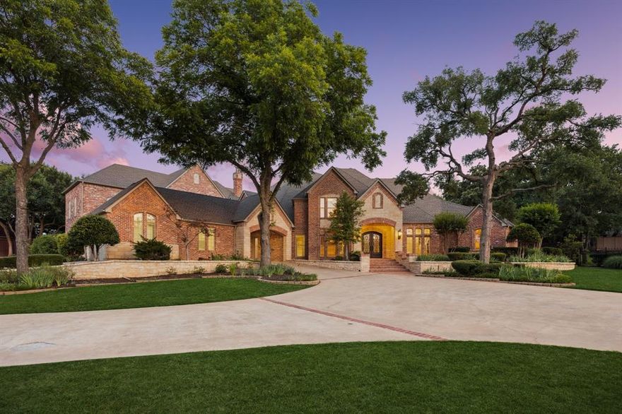 Discover unparalleled luxury at this magnificent 7,521 sq ft plus 2,053 sq ft guest quarters estate, on over 1.5 pristine acres on the prestigious N Peytonville. This architectural masterpiece features 6 bedrooms and 7 full bathrooms on the property, seamlessly blending elegance with entertainment. Exceptional guest quarters feature stone floors, rich wood ceilings, brick accents, Viking outdoor grill, stone gas fireplace, full kitchen, ensuite bedroom, and spacious upstairs loft. The gourmet kitchen in the main house showcases a premium 48 inch built-in Sub Zero refrigerator, Wolf gas range with double ovens, and stunning granite island with custom woodwork. Formal living boasts a marble fireplace, while the family room centers around a dramatic stone floor to ceiling fireplace and views of the outdoor oasis. The wine enthusiast's paradise includes a wrought iron door leading to a sophisticated bar with sonic ice, wine refrigerator, and custom bottle shelving. Entertainment abounds with two game rooms—one featuring a floor-to-ceiling stone fireplace and oversized bar with onyx countertops—plus a tiered media room with projection system. The thoughtful dog room includes a washing station and gated turfed area. The primary sanctuary offers travertine floors, private backyard access, and a spa-like ensuite with jetted tub, walk-in shower, two vanities, and two cedar walk-in closets. The resort-style backyard showcases custom landscaping with palm trees galore, sparkling pool and spa with waterfall, and covered outdoor living. Complete with 4-car garage—this is luxury living redefined. Carroll ISD!