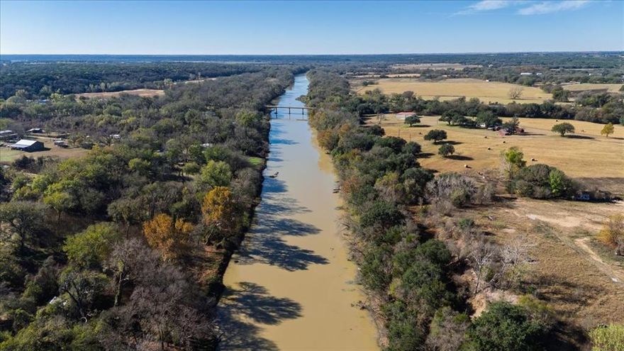 Rare Brazos Riverfront Opportunity – ±94 Acres
This exceptional ±94-acre property along the Brazos River is a rare find, offering the perfect combination of accessibility, recreation, and natural beauty. With 1,200 feet of highway frontage and 500 feet of direct river frontage, you won’t be driving miles down dirt roads to reach it. The river access is beach-style, making it easy to launch boats and enjoy the water.
A beautiful build site sits overlooking the river, ideal for creating your dream home or retreat. The land provides incredible fishing and hunting opportunities, with two planted oat fields designed to draw in monster bucks. The property also offers a mix of open fields and thick wooded areas, creating diverse habitats for wildlife and giving you both scenic views and privacy. A hunting cabin or lodge is already in place for weekend getaways or guest accommodations. A brand-new 30x50 spray-foamed shop adds valuable utility for equipment, storage, or projects, and all utilities are already installed, making the property ready for immediate use.
Whether you envision a private sanctuary, a recreational retreat, or a legacy property to enjoy for generations, this Brazos River tract delivers unmatched versatility and outdoor lifestyle appeal.