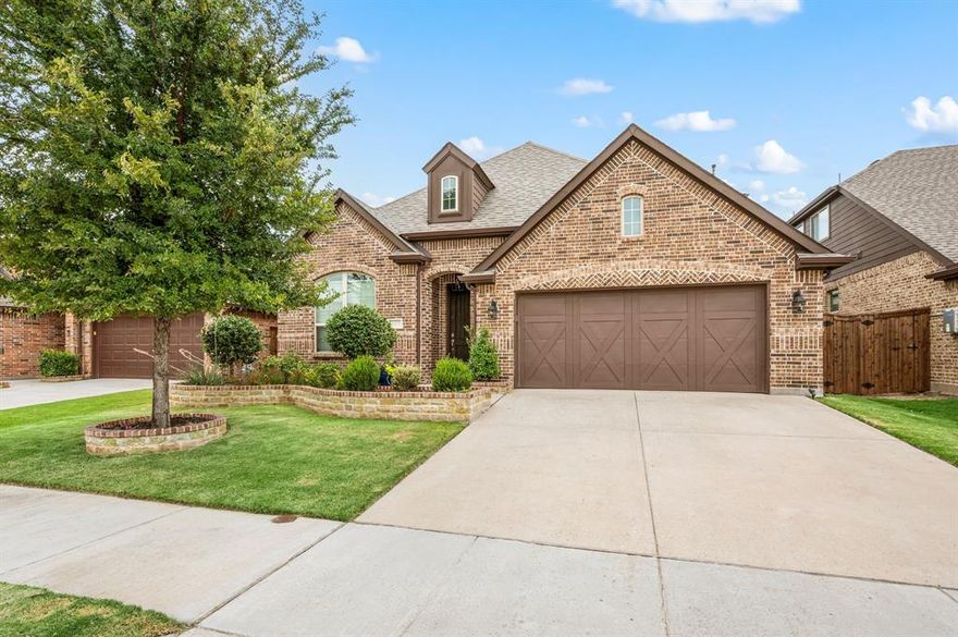 Welcome to this beautifully designed 4-bedroom, 2.5-bath home in the prestigious Berkshire community, located in highly sought-after Northwest ISD. Thoughtfully crafted for both everyday living and entertaining, this home offers a rare layout with all four bedrooms conveniently located on the main level, plus a spacious upstairs flex space with a half bath—perfect for a game room, media room, or second living area. Step inside to discover gorgeous decorator touches throughout, complemented by wood-look flooring in the main living areas and new carpet replaced in September 2025. The inviting open-concept floor plan features a living room anchored by a stunning floor-to-ceiling stone fireplace, creating a warm and impressive focal point. The heart of the home is the kitchen, featuring a large island ideal for gatherings, a gas cooktop, and stainless steel appliances, all overlooking the dining and living spaces for seamless flow. The private office is a standout, showcasing double barn-door entry, custom built-in shelving, and a built-in desk—ideal for remote work or study. The primary suite is tucked away at the back of the home, offering added privacy and a peaceful retreat. Additional highlights include owned solar panels that help reduce monthly power bills with no lease costs, providing both efficiency and long-term savings. Curb appeal shines with a beautifully landscaped front yard accented by stone and brick borders, setting the tone for the quality found throughout the home. Residents of Berkshire enjoy resort-style community amenities, including a clubhouse, resort-style pool, playgrounds, catch-and-release fishing pond, and scenic hike and bike trails. This move-in-ready home combines style, functionality, energy efficiency, and an exceptional community lifestyle—a must-see in Northwest ISD.