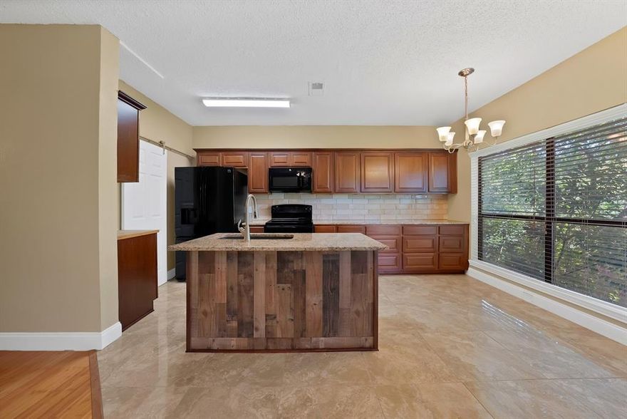 Updated Lake Highlands Condo with serene Creek Views!!  Discover the perfect blend of modern comfort and natural beauty in this beautifully updated 2-bedroom, 2-bath condo located in the Oaks-On-The-Bend community in Lake Highlands. This second-level unit backs to a lush greenbelt and peaceful creek, offering rare, scenic views right from your private balcony.  A private outdoor storage closet adds even more convenience.  Inside, the layout is bright and functional, featuring wood-look flooring. The updated kitchen boasts granite countertops, sleek black appliances, and plenty of cabinet space, all open to the cozy living area with fireplace and large windows that bring in tons of natural light. The spacious primary suite includes an en-suite bath and two closets, while the second bedroom offers great flexibility for guests, office, or both.  Washer, dryer, and refrigerator all convey with the home, making this move-in ready and ideal for both homeowners and investors.  Enjoy access to a well-maintained community pool and beautiful landscaping, with pet-friendly amenities including convenient disposal stations and well-lit pathways throughout the complex. The HOA covers water, sewer, and trash—so no water bill! Assigned covered parking is included, and the community is well-situated within Richardson ISD.  Just minutes from White Rock Lake, NorthPark Center, SMU, Lower Greenville, and the medical district, this location offers exceptional access to dining, shopping, fitness centers, and major highways. DART access is nearby, making commuting easy and convenient.  FHA and VA loans not eligible in this complex.  Two-bedroom, two-bath units with a greenbelt view are hard to come by in this community, making this a standout opportunity for buyers seeking both space and scenery!