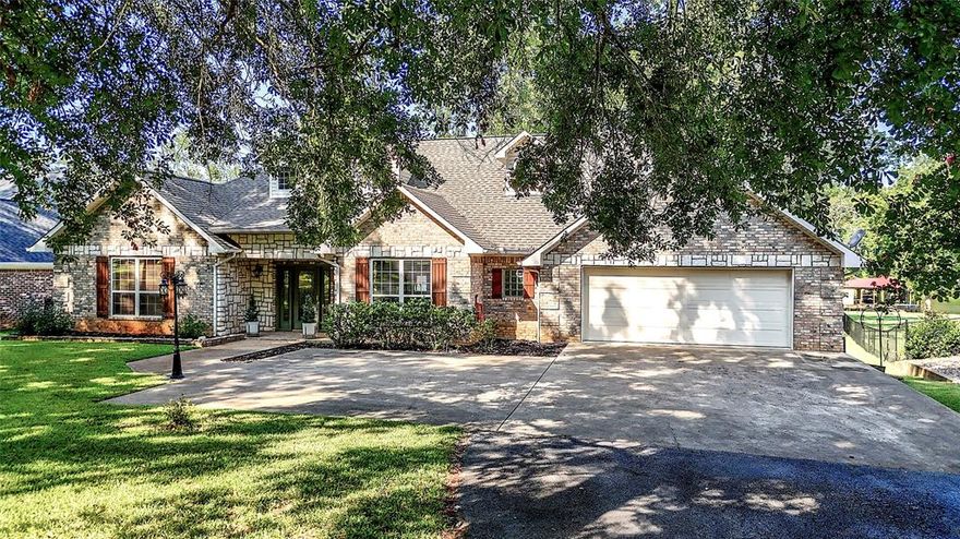 Located on the peaceful yet sought after fishing inlet of Stone Chimney Cove on Lake Palestine, this custom-built steal framed home offers unparalleled comfort and breathtaking views. As you drive down the long, tree-lined driveway, you're welcomed by the natural beauty and privacy of this exceptional property. Step inside and be captivated by the vaulted living room anchored by the floor-to-ceiling stone fireplace. Designed for both relaxation and effortless entertaining, this home blends elegance with practicality. All of the lakeside rooms across the back of the home feature expansive picture windows allowing in natural light and ensuring the incredible lake views are always within reach. A whole house generator adds peace of mind and enduring comfort during extreme weather. With 134' of shoreline and a single slip boathouse, you will have access to a lifetime of enjoyment on beautiful Lake Palestine.