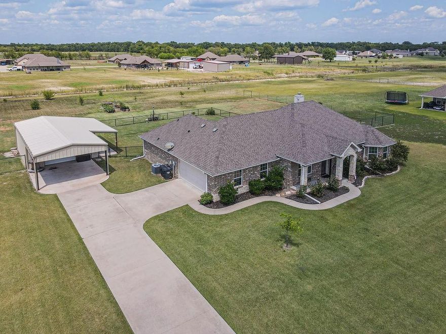 Nestled in the cozy Caddo Fork Estates neighborhood, this beautifully maintained 4 bedroom home with an additional office offers the perfect balance of comfort, function, and space. Featuring 2 full baths and a desirable split-bedroom floorplan, this property is designed for both privacy and togetherness. The open-concept living area boasts a stone fireplace as its centerpiece, seamlessly connecting to a spacious kitchen with a breakfast bar, eat-in dining area, flat cooktop, built-in oven and microwave, and plenty of cabinetry. The primary suite includes a large walk-in closet, linen closet, separate sinks, and a spacious walk-in shower for a spa-like touch. Step outside to a covered back patio overlooking your 1.5-acre cross-fenced yard, complete with an updated sprinkler system to keep the landscaping lush. For hobbyists or extra storage, the property includes a 20x30 foam insulated shop with roll up doors in the front and back, a 20x20 carport for extra covered parking, and an attached 10x30 shop patio that's perfect for entertaining or projects year round. With room to roam, plenty of parking, and a blend of rural charm in a neighborhood setting, this home is ready to meet all your lifestyle needs.