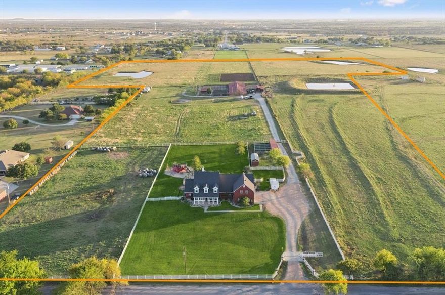 Escape to a rare opportunity where wide-open skies, premier equestrian facilities & refined residential living come together on approximately 42 acres just minutes from Denton & US-380, offering prime frontage & sweeping views of rolling pastures, mature trees + 3 serene ponds. Included on the 42 acres is 2751 Mitchell Rd, a Residential home built in 2008 w-over 5,600 SF, 4 bed, 3.5 bath ranch designed for both everyday comfort & effortless entertaining, featuring a dedicated home office, gourmet kitchen flowing into formal & casual dining spaces, great sized bedrooms & entertainment-ready spaces including a fully equipped media + game rm w-wet bar. Step outside to a 40,000-gallon saltwater pool, perfectly positioned for relaxing under the Texas sun while taking in peaceful, panoramic views of the land. This exceptional property is equally equipped for serious equestrian or ranch use, showcasing a 200X150 arena, 23 indoor stalls w-potential to expand to 40, and over 9,000 SF of covered barn & support space. The nearly all-connected barn complex includes a heated & air-conditioned 50X40 front barn, west stalls measuring 30X30, a 40X10 wash room w-mini-split & water heater, a spacious tack area w-both enclosed & under-roof space featuring dual mini-split systems, a 50X100 covered stall area w-water, electric + lighting to each stall, a 24x20 shop with propane heater & attached 30x40 awning, a 10x40 Conex container w-window AC & electric + a small shed connected to the west stalls. The property is supported by a functioning well and aerobic system offering both independence & convenience, while expansive acreage & excellent road frontage provide outstanding flexibility for future development, agricultural use, or a legacy estate. Whether envisioned as a premier equestrian operation, a private family ranch, or a high-potential investment, this Denton-area property delivers Texas-sized space, infrastructure & lifestyle in one remarkable offering.