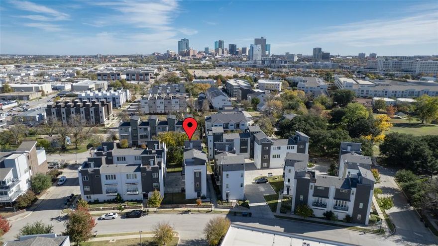 One of Fort Worth’s most exclusive modern residences, offering luxury finishes, thoughtful upgrades, and an unbeatable Cultural District location. Built in 2022, this beautifully crafted 3-bed, 4-bath home blends contemporary elegance with true lock-and-leave convenience just steps from the best of Fort Worth. Inside, an open, light-filled layout features rich wood floors and designer lighting. The spacious living and dining areas flow into a chef-inspired kitchen with quartz countertops, custom ceiling-height cabinetry with glass uppers, statement backsplash, farmhouse sink, and KitchenAid stainless appliances including a 5-burner gas cooktop, stainless hood, and convection oven-microwave. Sleek iron railings, upgraded hardware, and refined finishes continue throughout. Upstairs, the primary suite lives like a private retreat with frameless glass shower, dual vanities, and modern tile. Two additional bedrooms with walk-in closets share a stylish full bath. A private 4th-floor rooftop terrace offers space for relaxing, entertaining, and enjoying sweeping views. The brick-and-stone façade, cedar garage door, and enhanced exterior lighting elevate curb appeal. Additional upgrades include energy-efficient windows, tankless water heater, radiant-barrier decking, two EV chargers, surround-sound and security prewire, garage storage racks, and a ceiling-mounted Wi-Fi access point with extenders. All minutes from Dickies Arena, Will Rogers, Canyon Ranch Wellness Club, museums, restaurants, shopping, fitness studios, and the Trinity Trails. This move-in-ready home delivers modern elegance and an exceptional Fort Worth lifestyle.  This house comes with a REDUCED RATE as low as 5.75% (APR 6.016%) as of 12-30-2025 through List & Lock™. This is a seller paid rate-buydown that reduces the buyer’s interest rate and monthly payment. Terms apply, see disclosures for more information.